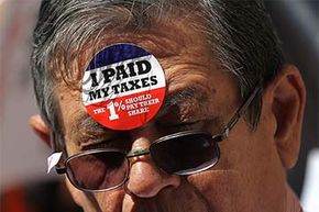 A protestor wears stickers on his face during a Tax Day demonstration in New York City. Dozens of protesters demonstrated against loopholes that allow banks and corporations to pay lower income taxes than most individual filers.
