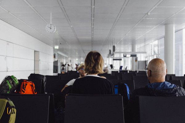 Two people sitting on seats in an airport lounge